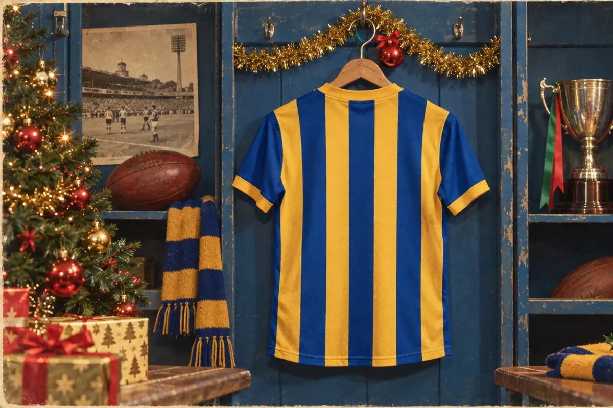 A blue and gold striped football jersey on a hanger in a locker room, with tinsel and a bauble on the hook, a scarf, a football and a trophy on the shelves.